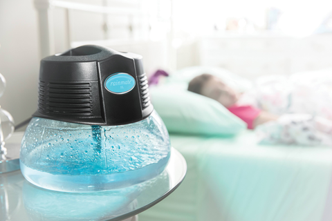 Rainmate water-based air purifier on a bedside table